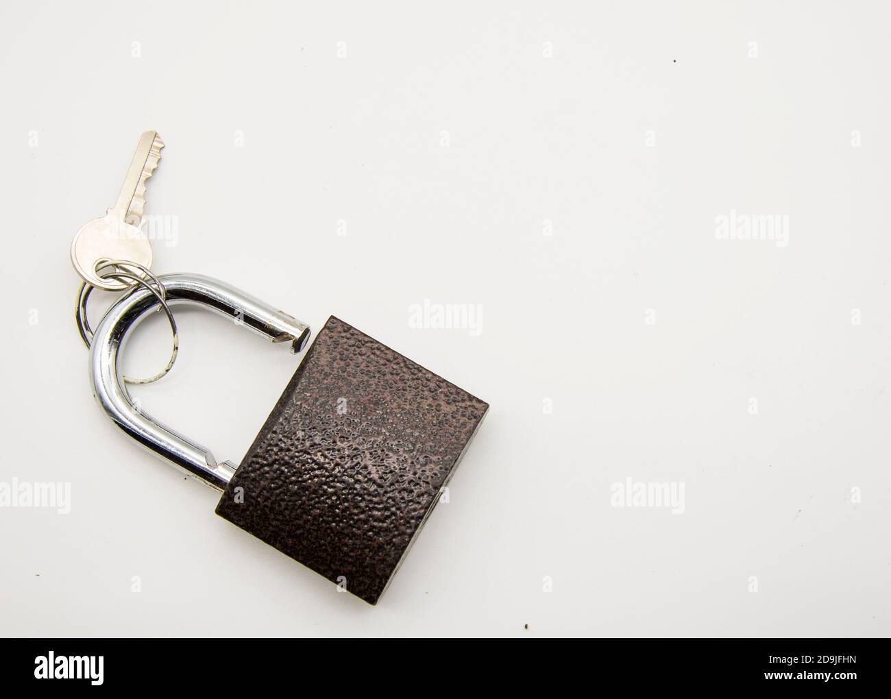 Metal padlock with key on white background Stock Photo - Alamy