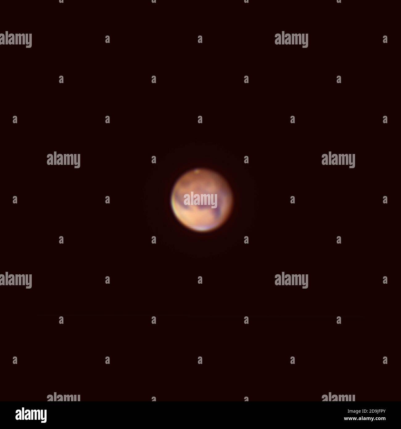 Planet Mars photographed from London UK on 5.11.20 using R,G,B colour filters on monochrome camera and 4' refracting telescope. Martian South polar ice cap is at top of image. Stock Photo