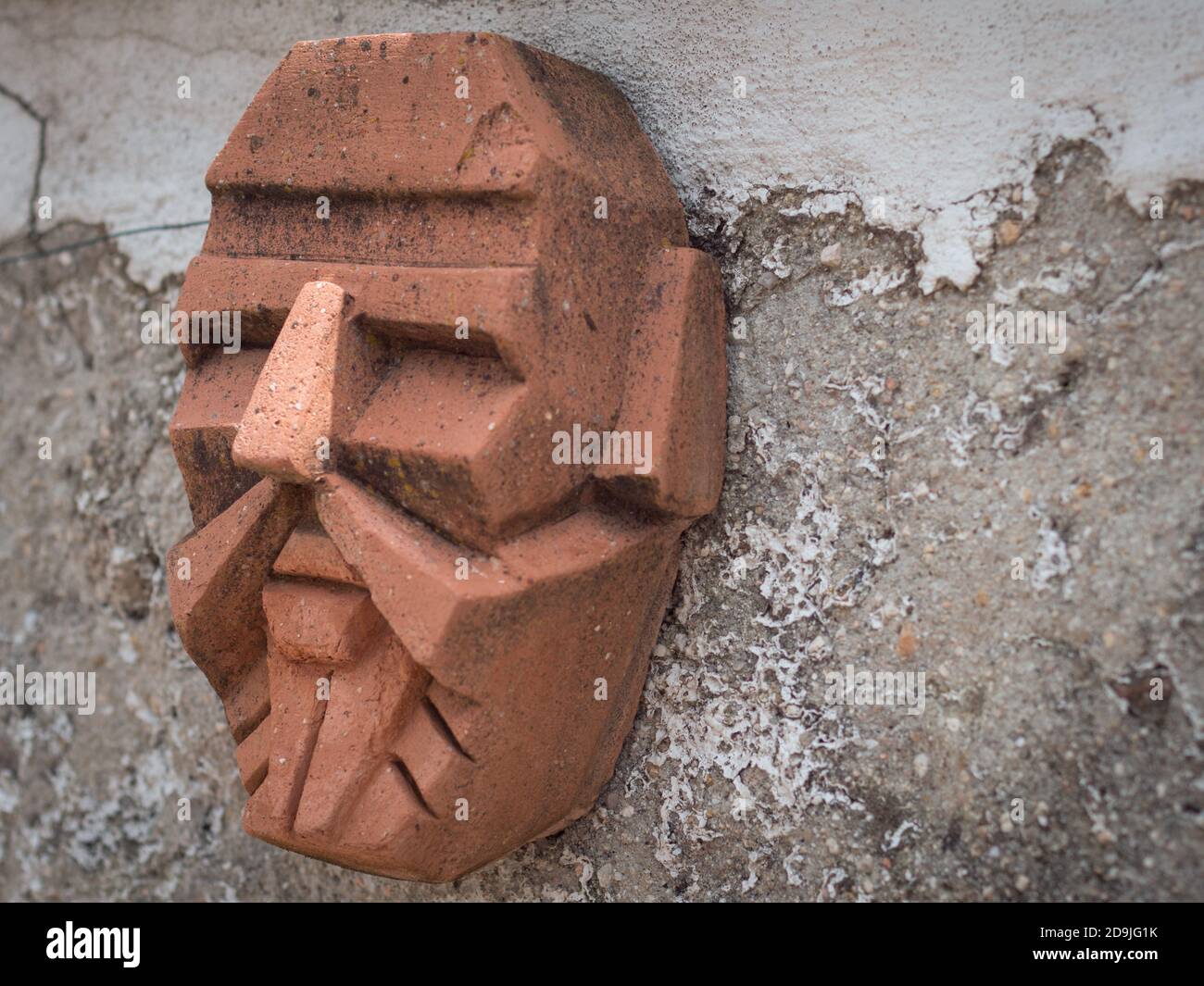 Side view of  terracota male mask with futuristic aspect. Stock Photo