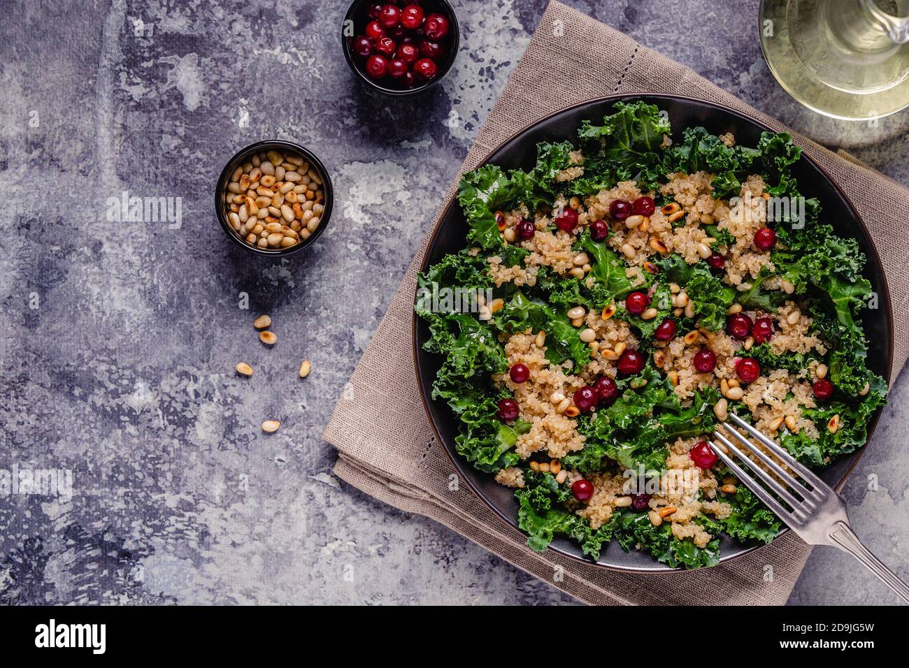 Healthy raw kale and quinoa salad with cranberry and pine nut. Top view