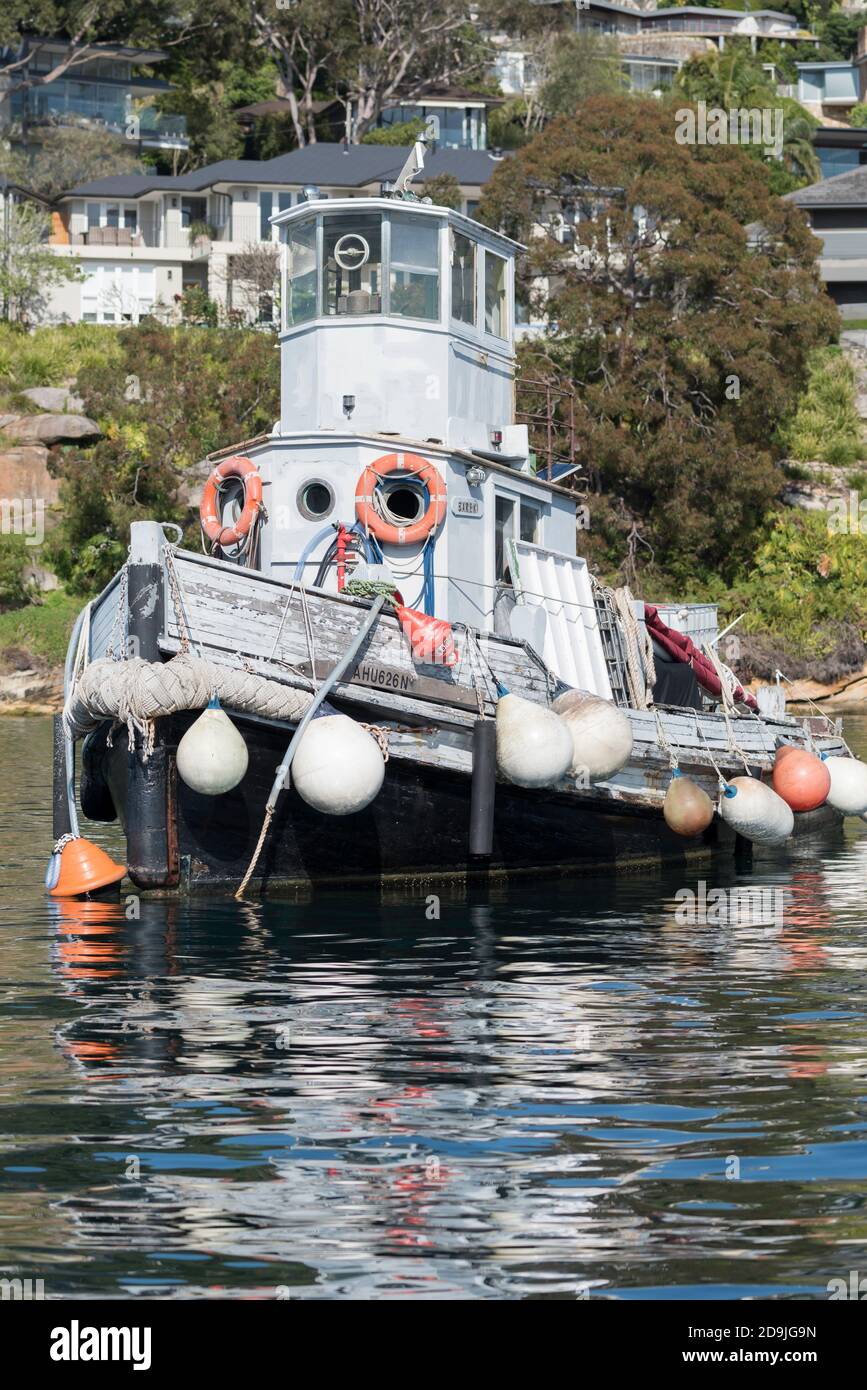 A series of buoys hang over the side of an old wooden tug in Sydney Harbour, New South Wales
