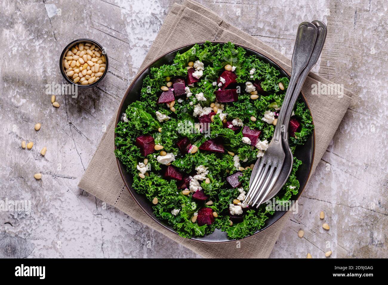 Healthy raw kale and beetroot salad with feta cheese and pine nut. Top