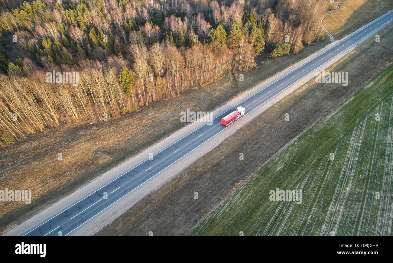 Heavy empty truck driving on road above drone view Stock Photo