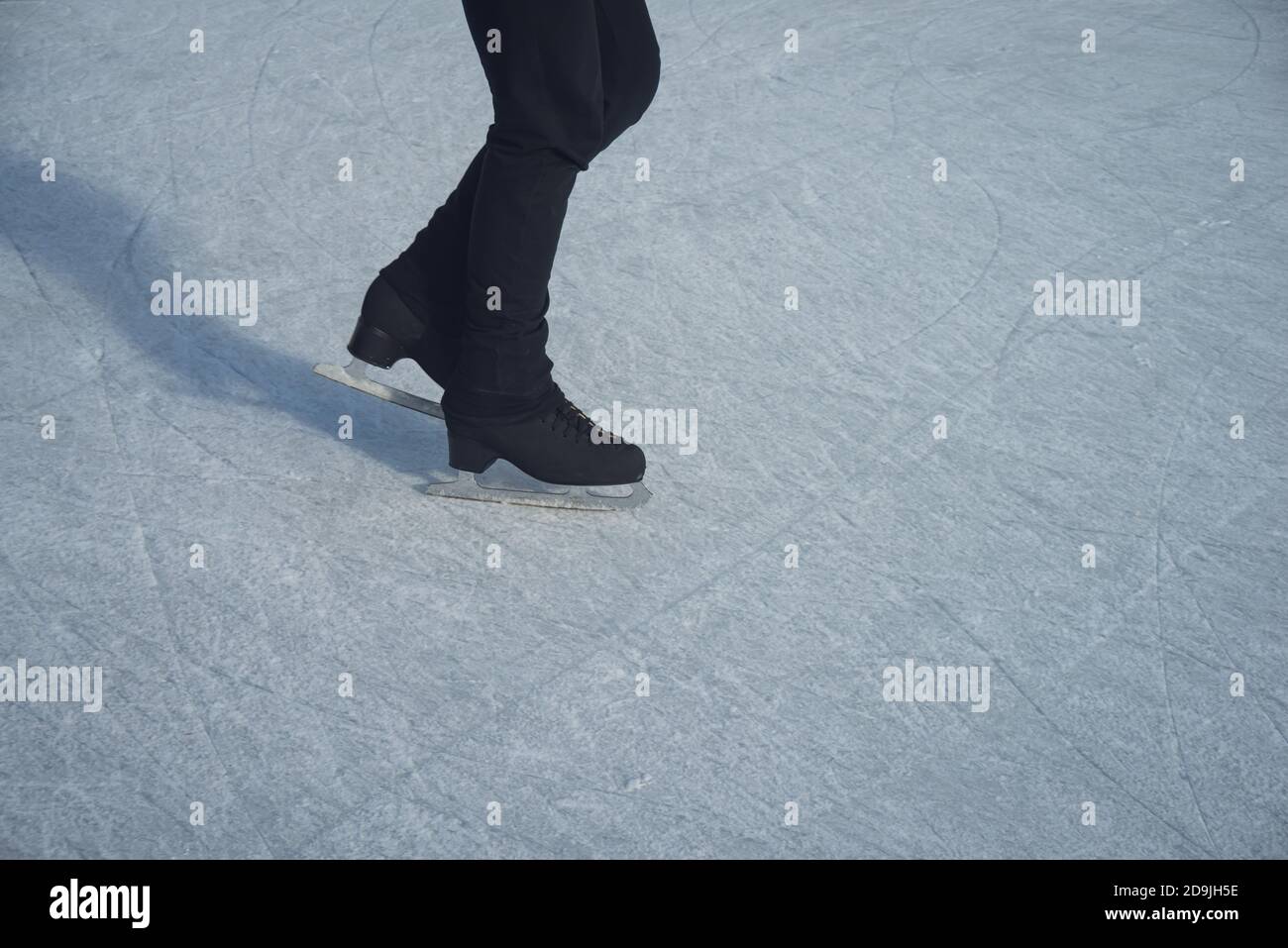 male ice skater , on the ice close up on legs . Stock Photo