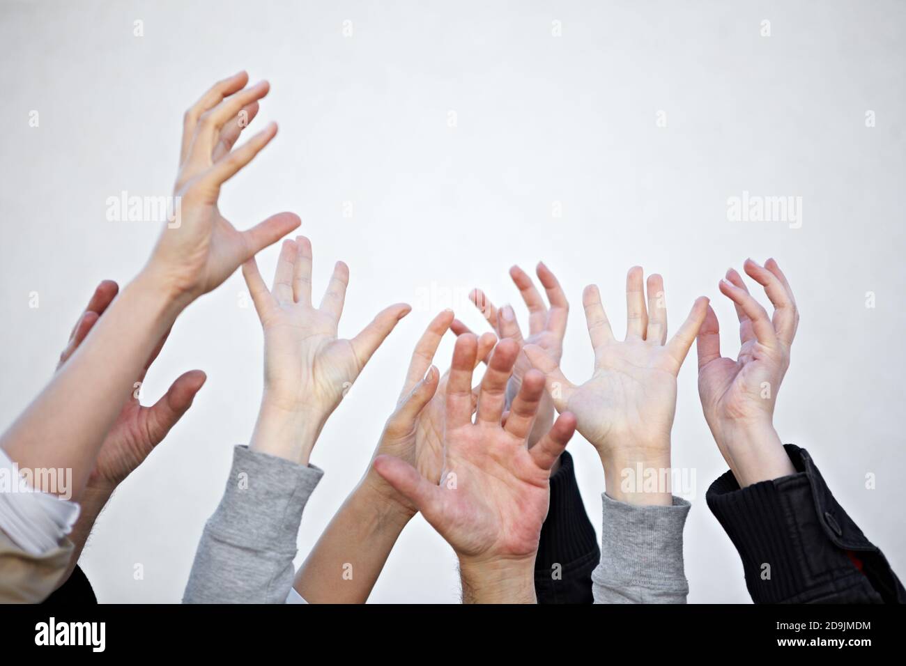 Many hands reach up Stock Photo