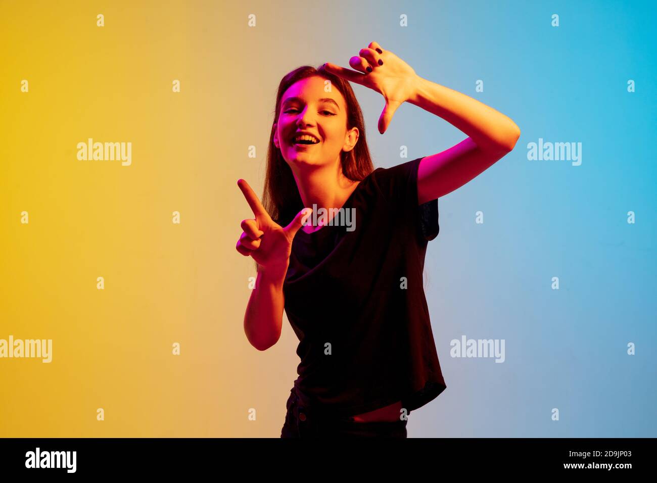 Framing. Young caucasian woman's portrait on gradient blueyellow