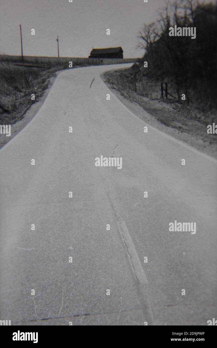 Fine 1970s vintage black and white photography on the road on a drive in the country. Stock Photo