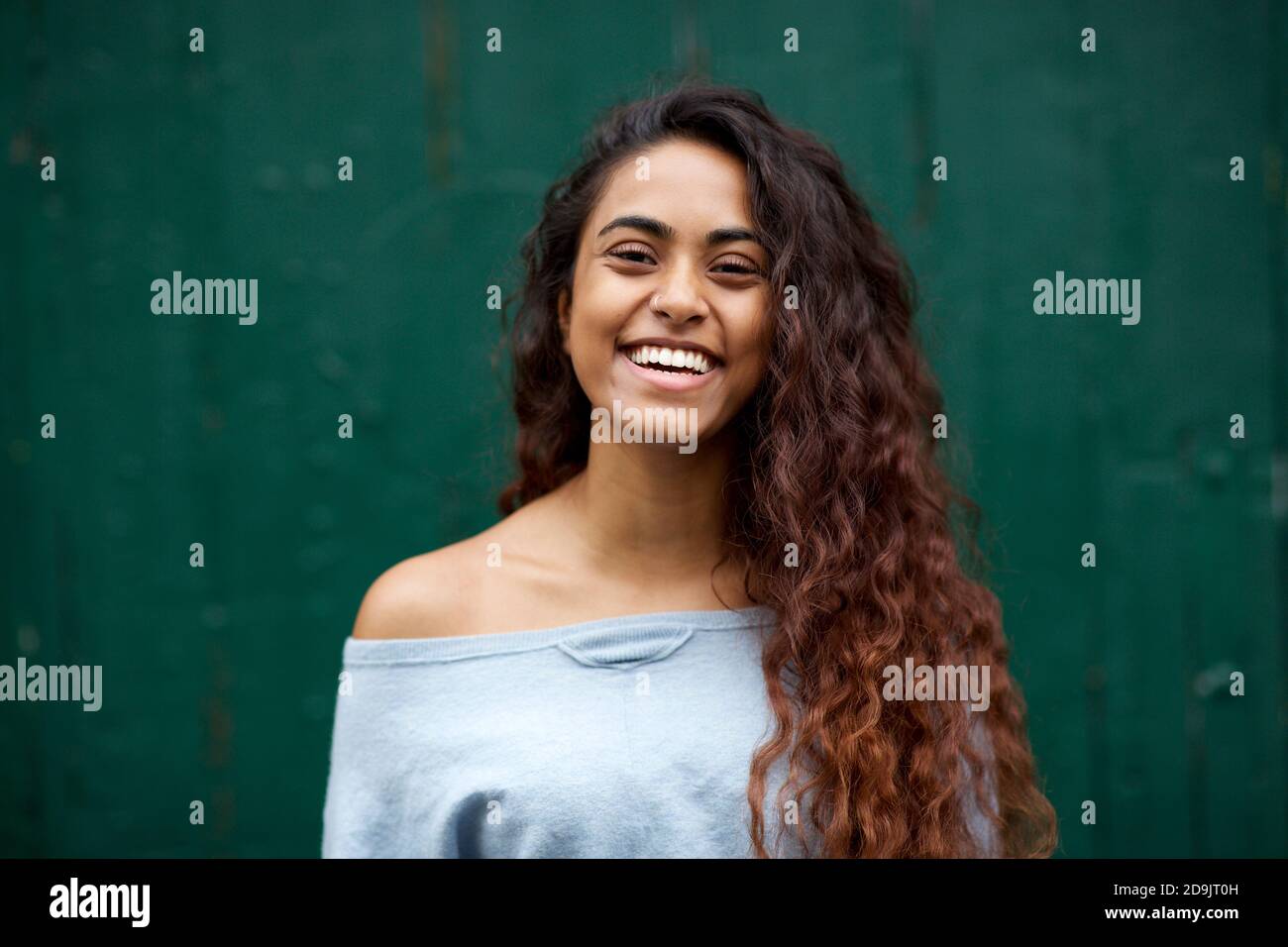 Close up portrait beautiful young Indian woman with long hair smiling ...