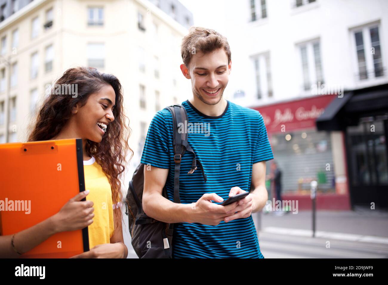 Man looking at phone walking street hi-res stock photography and