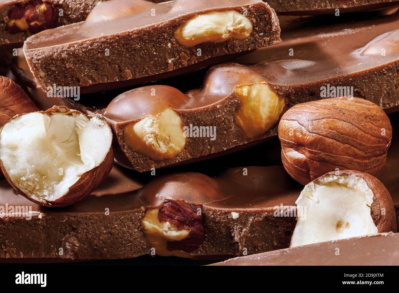 macro of stack of milk chocolate pieces and hazelnuts Stock Photo Alamy