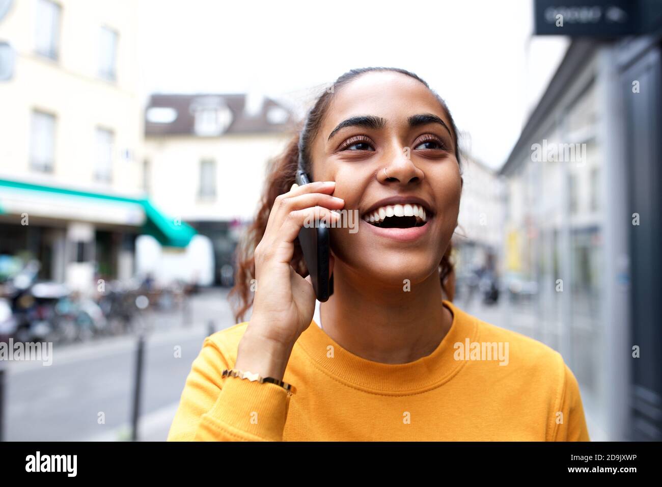 Close up portrait happy young indian woman talking with mobile phone ...