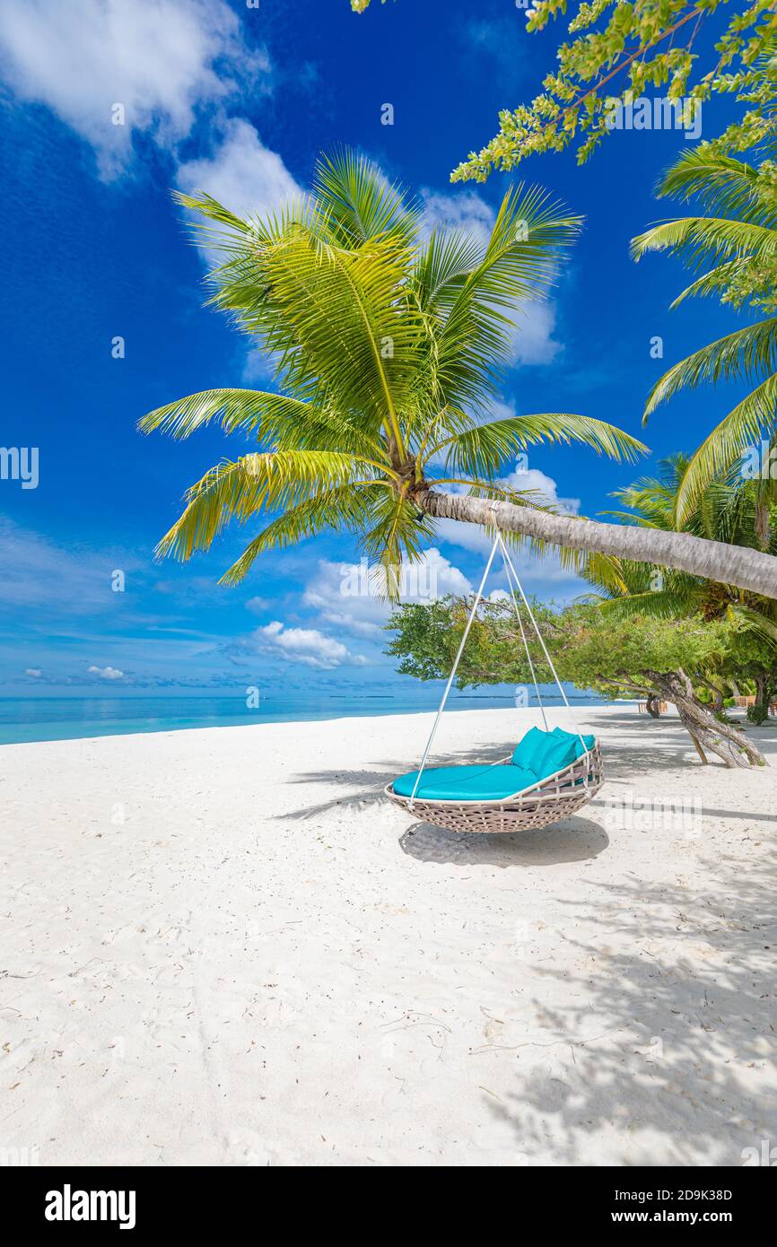 Tropical beach background as summer landscape with beach swing or hammock white sand and calm sea for beach banner. Luxury travel destination banner Stock Photo