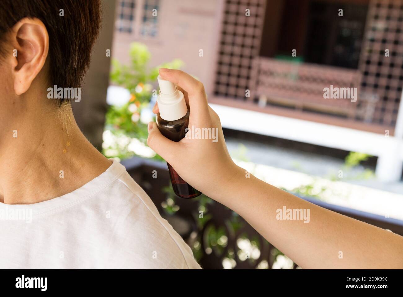 Person spraying organic insect repellent before go hiking outdoor Stock