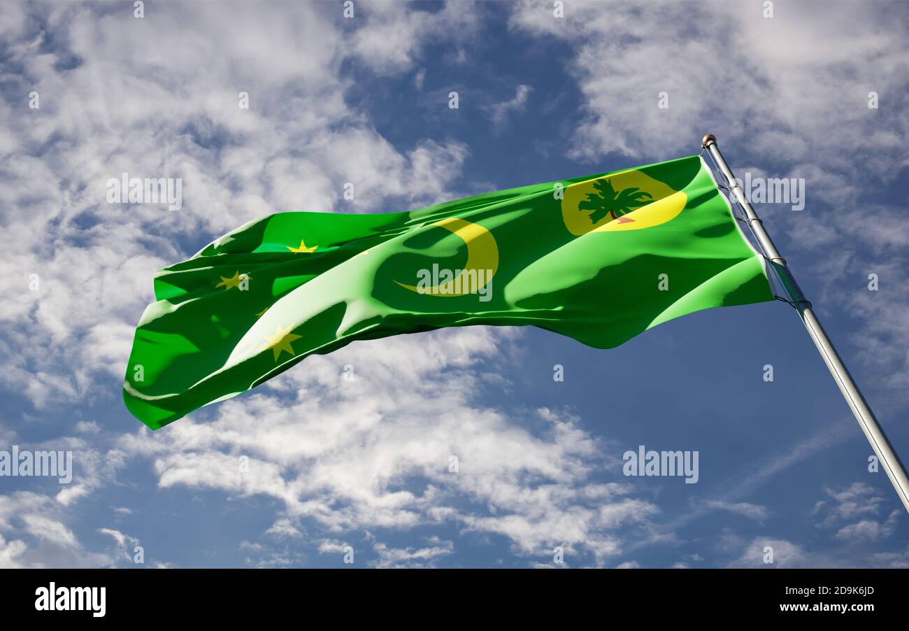 Beautiful national state flag of Cocos Island fluttering at sky ...