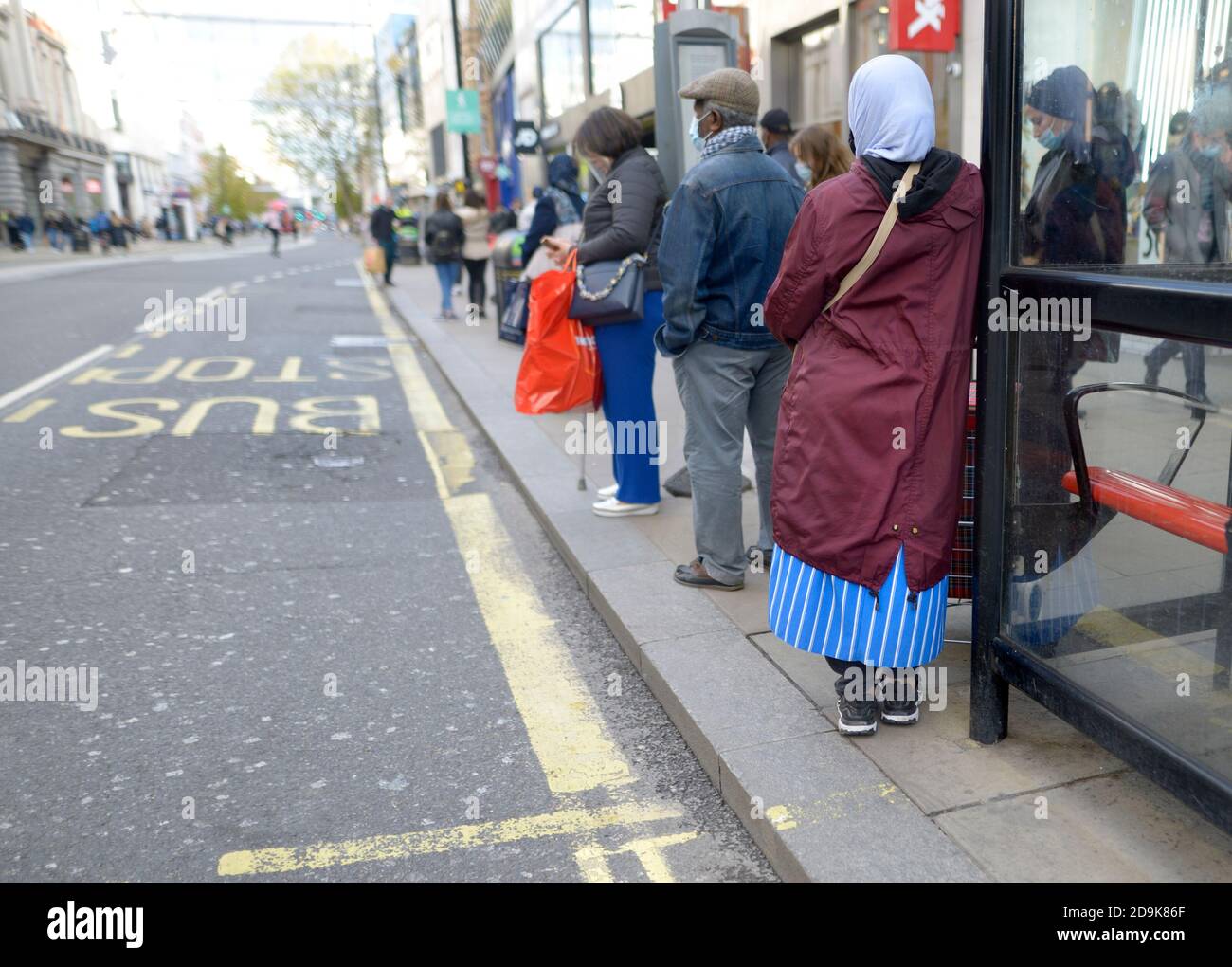 London, England, UK. People waiting at a bus stop in Oxford Street Stock Photo