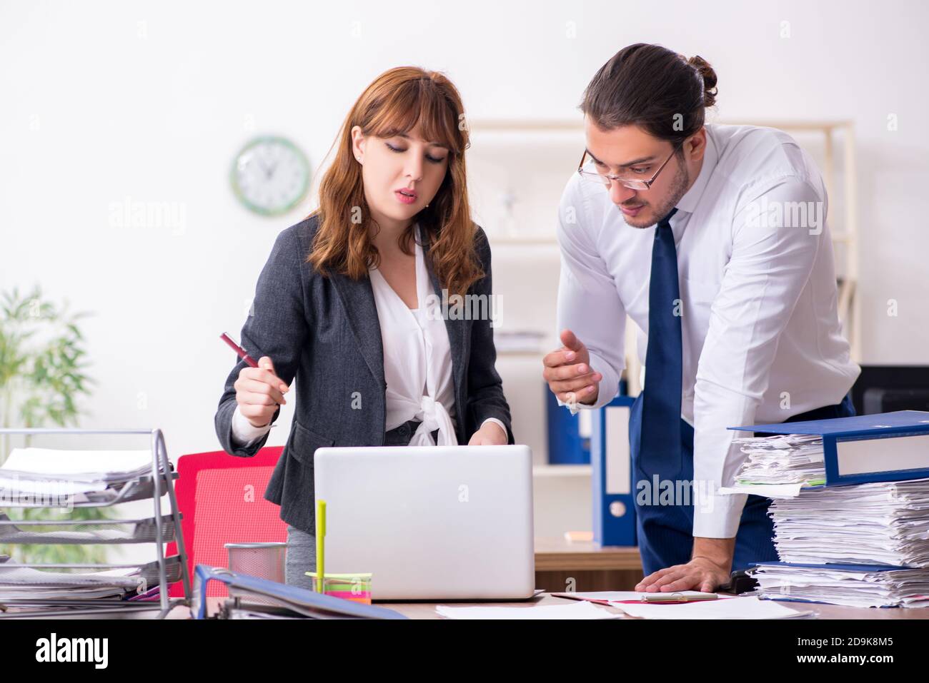 Two employees working in the office environment Stock Photo - Alamy