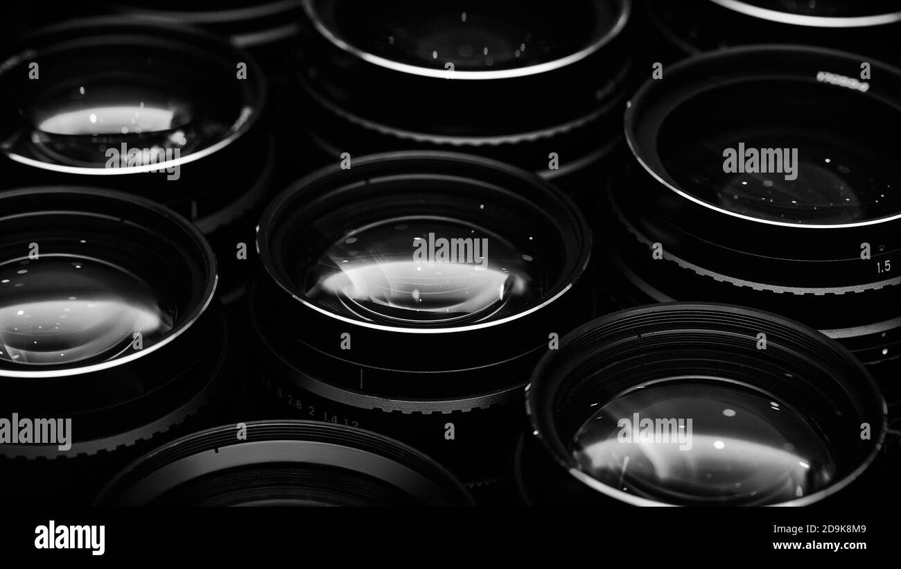 Highaperture camera lenses with reflections, low key image. High