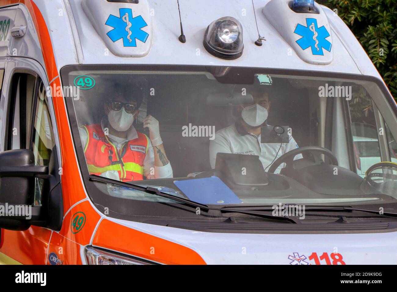 Doctors with protective mask inside an Italian ambulance due to the Coronavirus Covid-19 Stock Photo