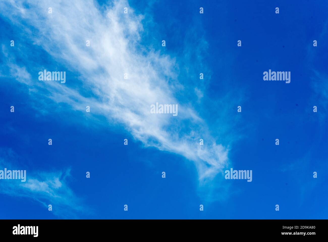 white wispy clouds on a bright clear blue sky Stock Photo