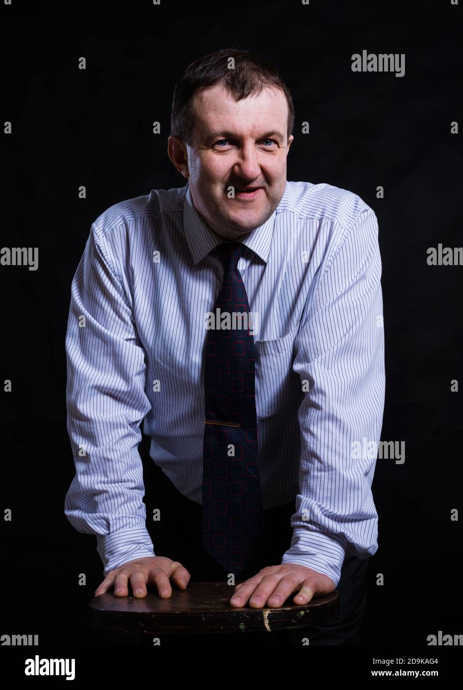 Solid Man Middle aged solid man dressed in shirt studio portrait on black ...