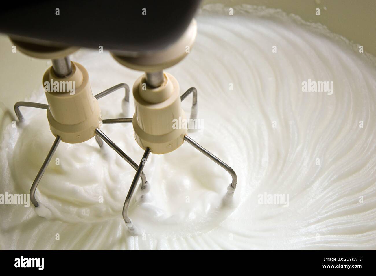 Closeup of whipped cream and mixer Stock Photo Alamy