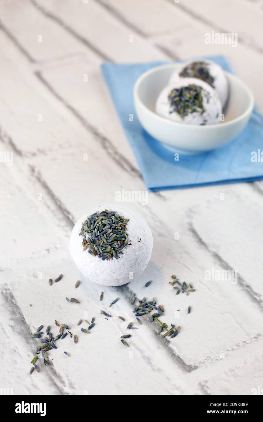 Handmade lavender bath bombs on white brick background Stock Photo