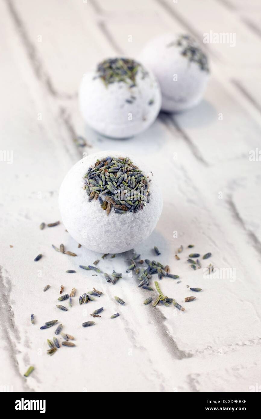 Handmade lavender bath bombs on white brick background Stock Photo