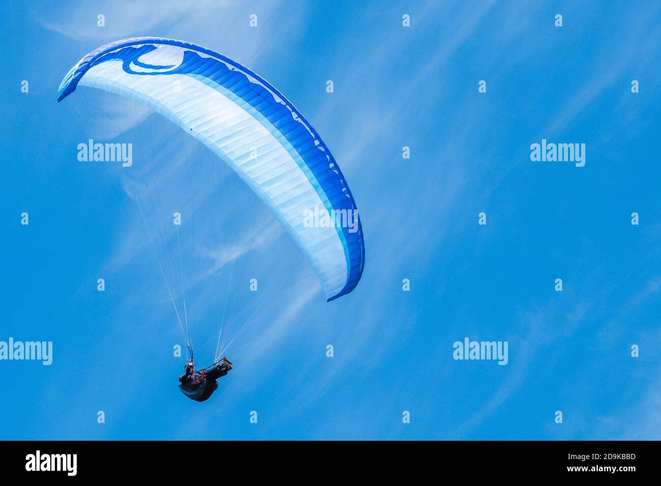 a paraglider follows the thermals along the top of the cliffs at the beach at Southbourne in Bournemouth, Dorset. 08 June 2014. Photo: Neil Turner Stock Photo