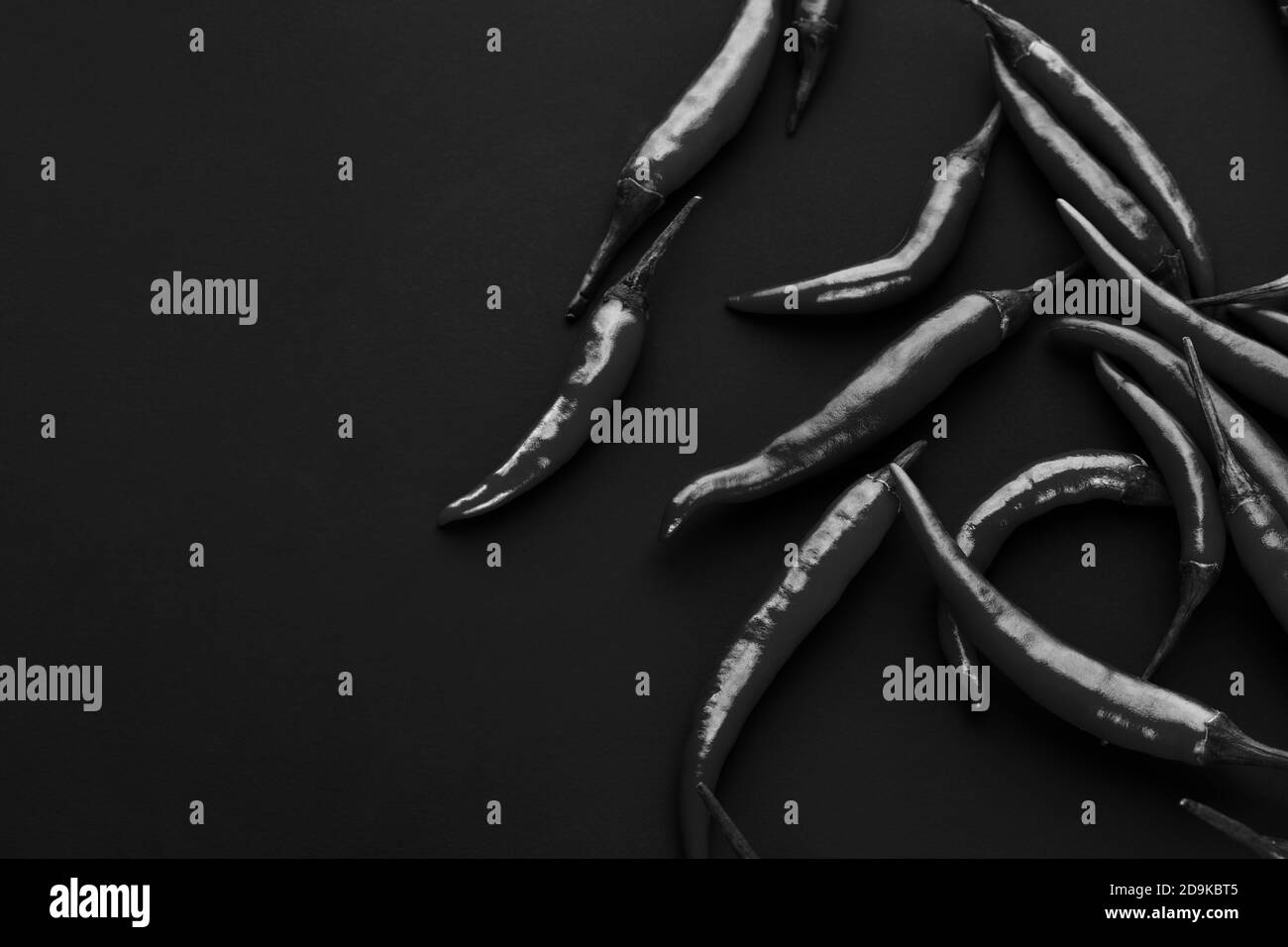 Red hot chili pepper on black background. Seasoning for real men. Fire seasoning Stock Photo