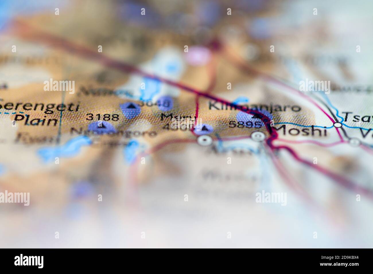 Shallow depth of field focus on geographical map location of Mount Meru in Tanzania Africa continent on atlas Stock Photo