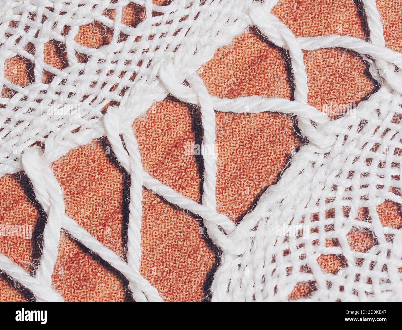 Closeup of white handmade lace on brown background Stock Photo