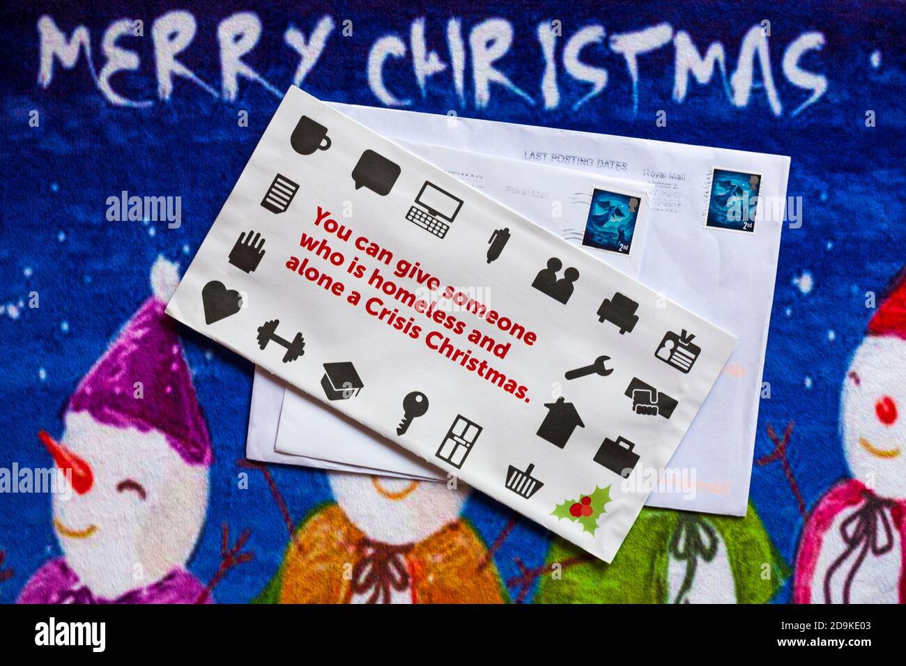 Post on Christmas mat - charity appeal, Crisis you can give someone who is homeless and alone a Crisis Christmas - Merry Christmas Stock Photo