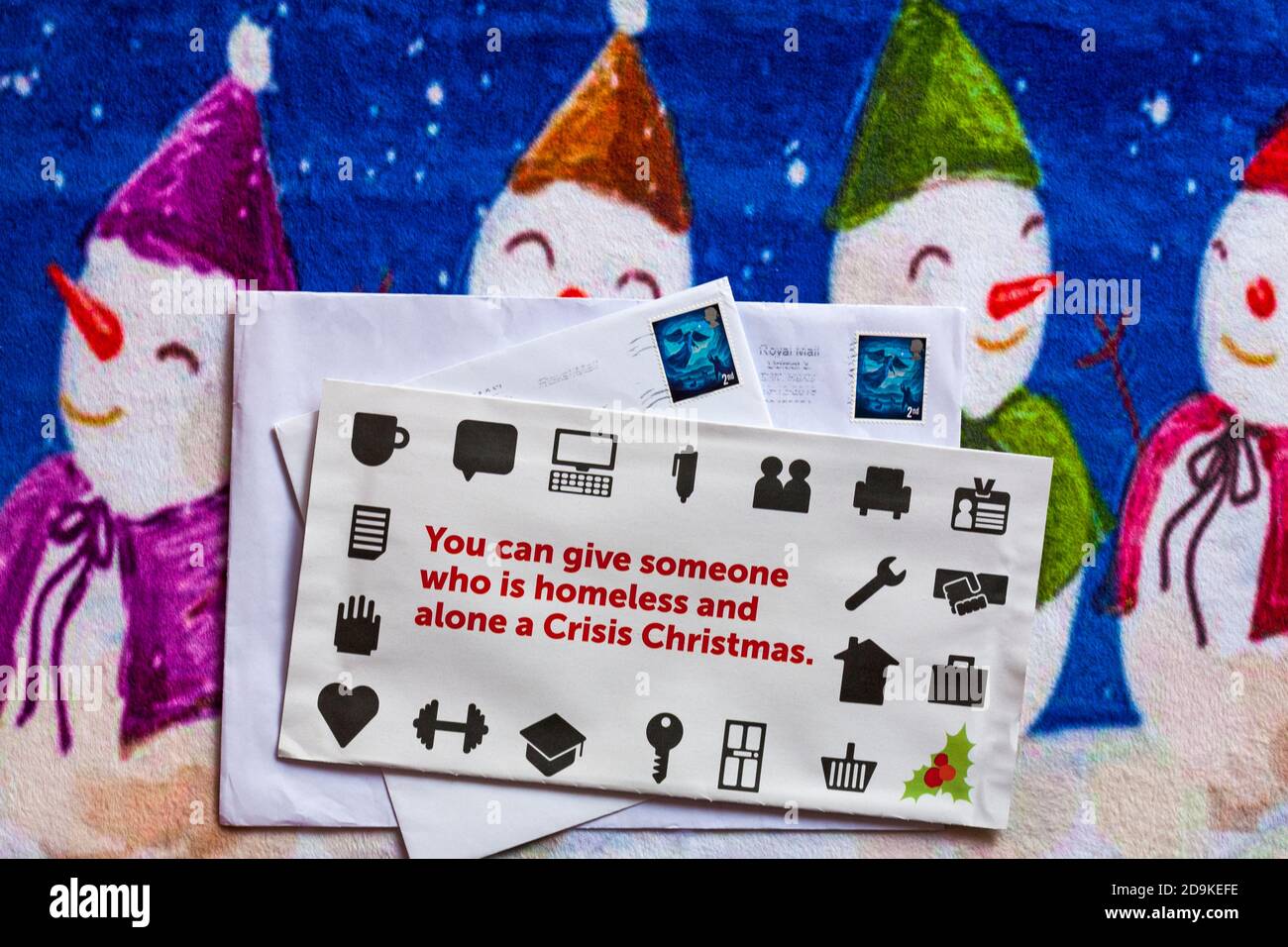 Post on Christmas mat - charity appeal, Crisis you can give someone who is homeless and alone a Crisis Christmas Stock Photo