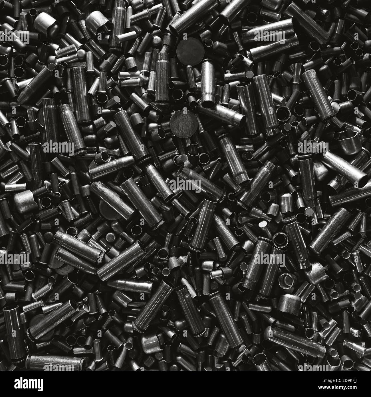 Different size bullet shells on the black ground. War concept ...