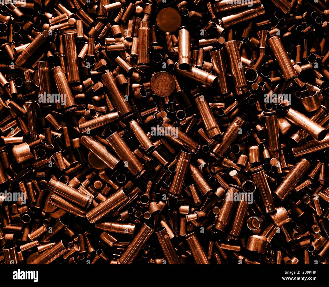 Different size bullet shells on the black ground. War concept