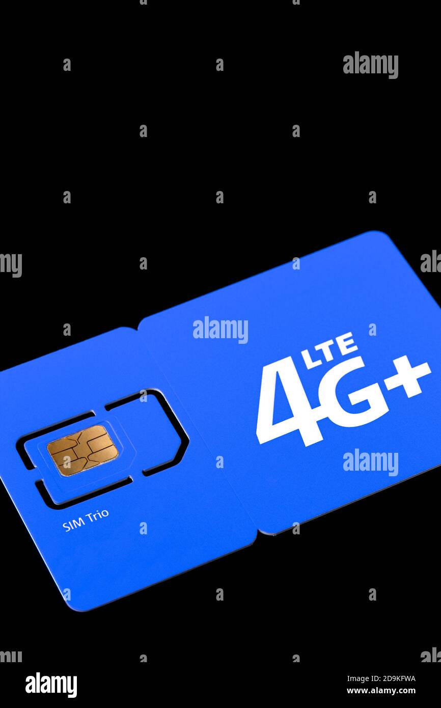 Size of sim card. Standard, micro and nano SIM card. SIM card for phone piled on a black background. Stock Photo