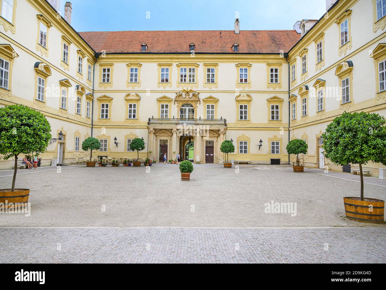 Tourists walk through garden from Valtice castle, UNESCO (Czech Republic) Stock Photo