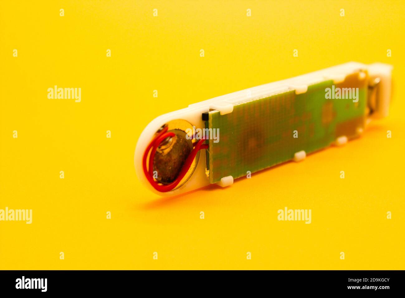 Digital thermometer isolated on yellow background with selective focus Stock Photo