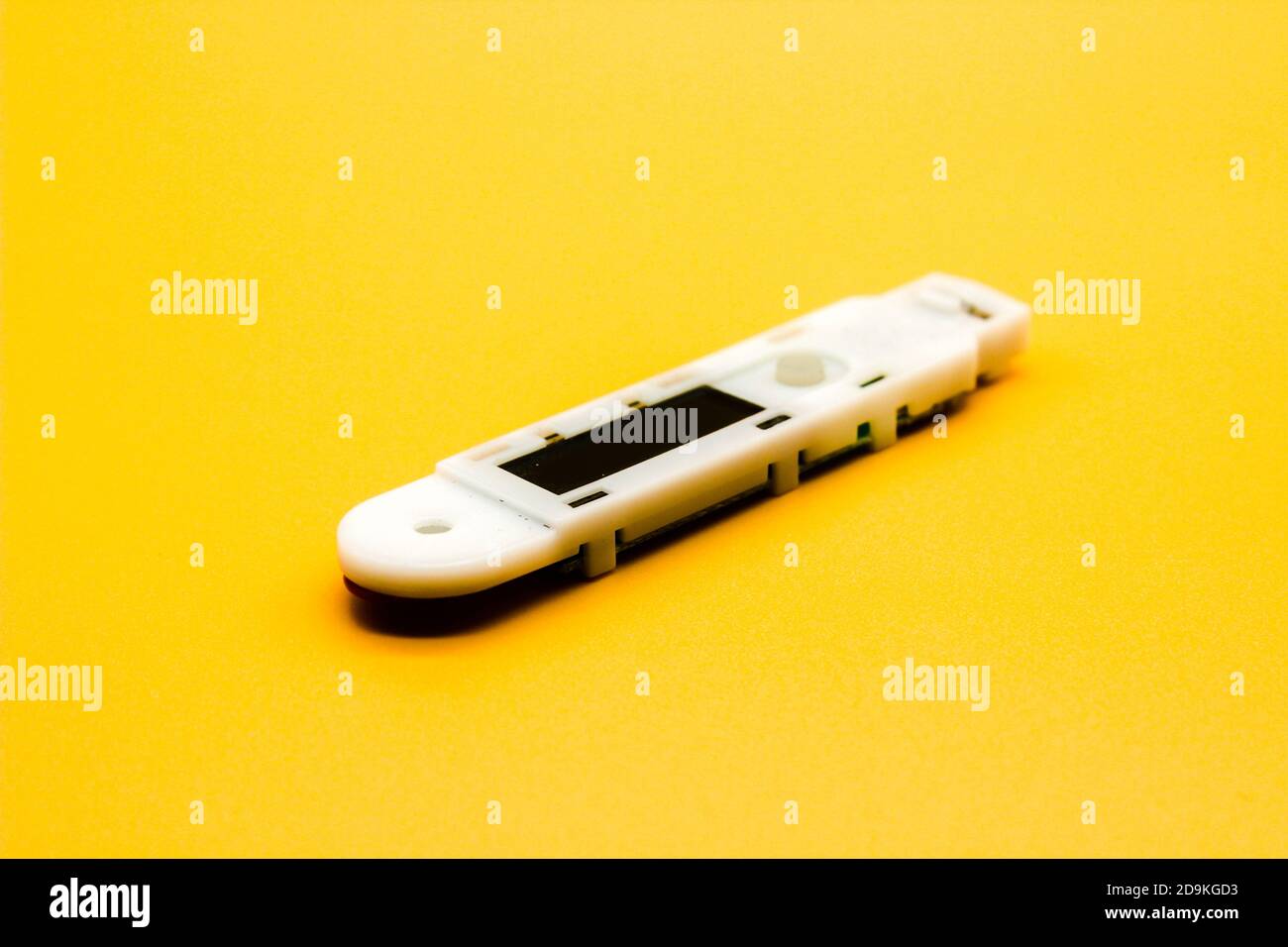 Digital thermometer isolated on yellow background with selective focus Stock Photo