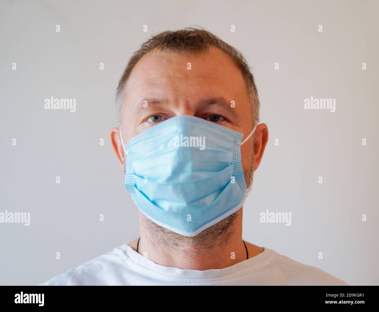 Man doctor with attantive eyes. Protective mask on his face. Stock Photo