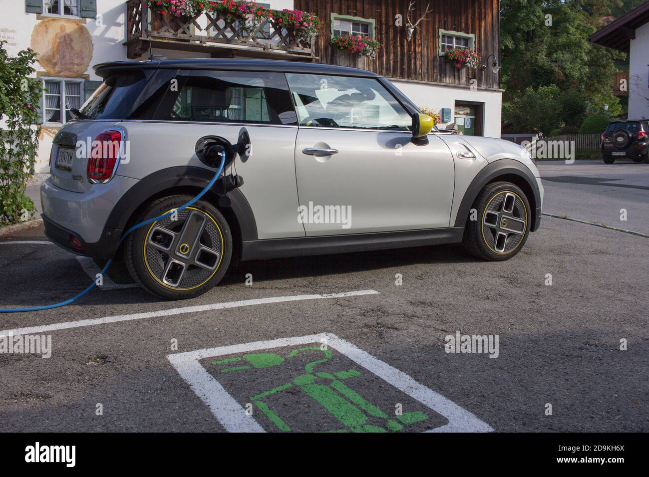 At the charging station with the electric Mini Cooper SE Stock