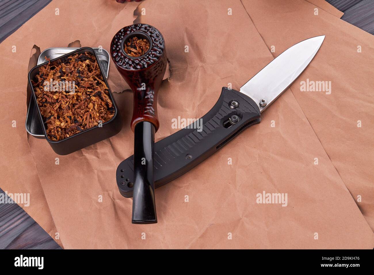 Composition of smoking pipe with tobacco and knife Stock Photo Alamy
