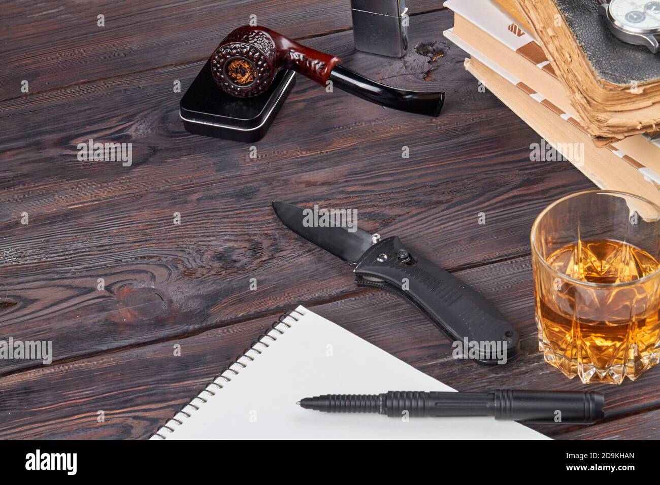 Short knife with smoking pipe and glass of cognac Stock Photo - Alamy