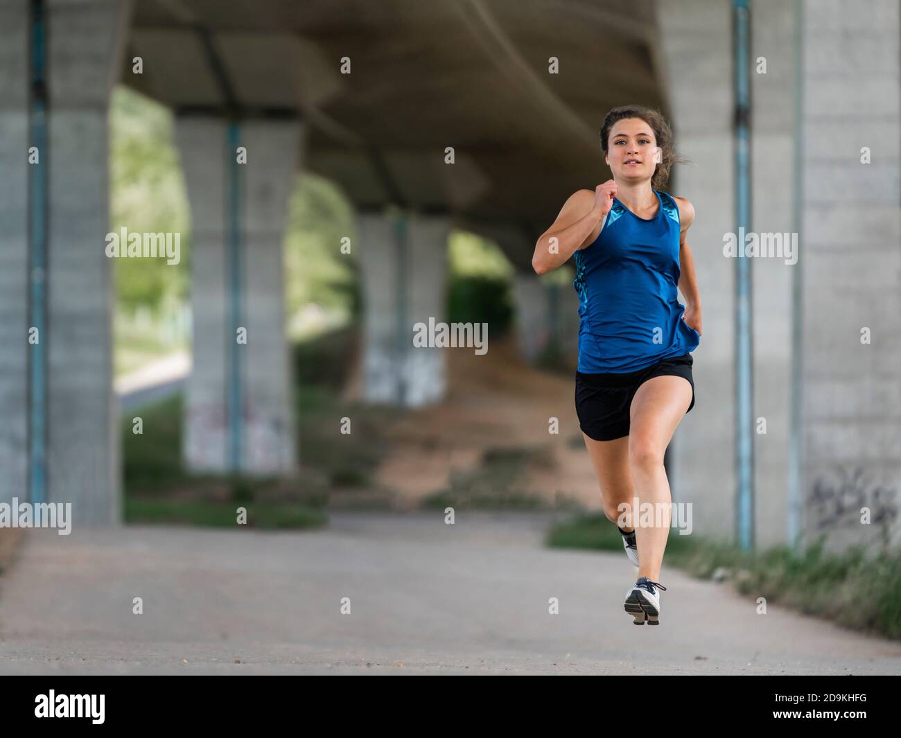 Woman, 24 years old, running under a bridge, Remstal, Baden-Württemberg, Germany Stock Photo
