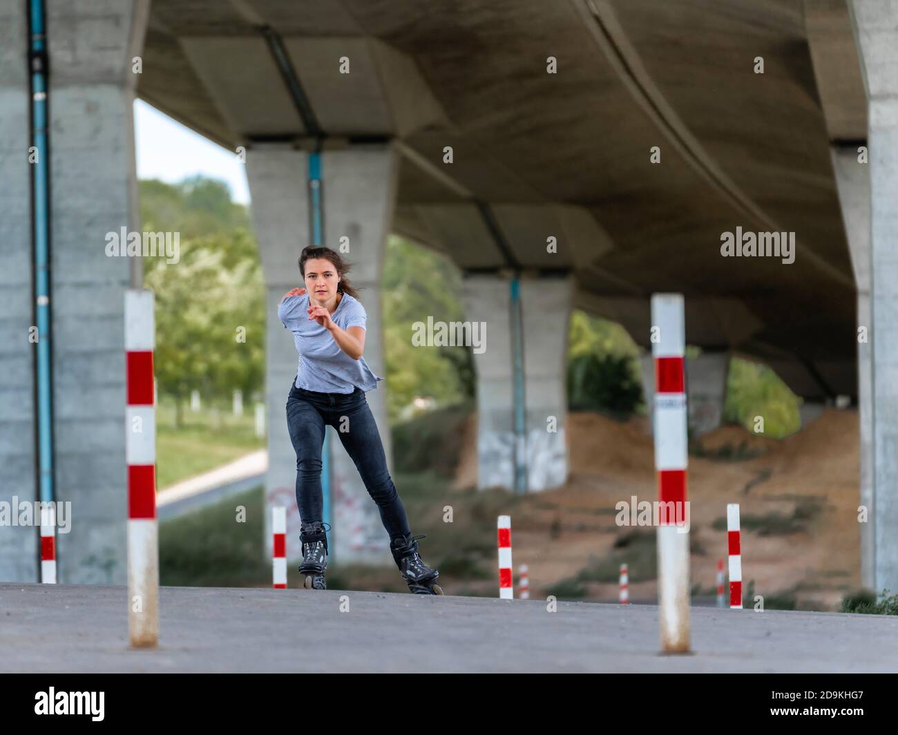 Woman, 24 years, inline skating under bridge, Remstal, Baden-Württemberg, Germany Stock Photo