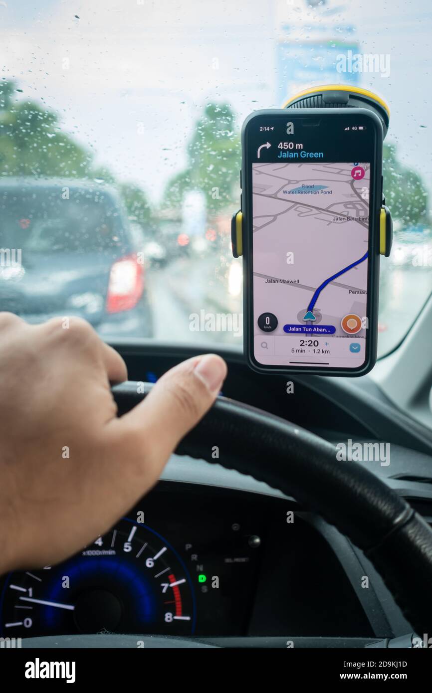An iPhone X with Waze navigation app inside the car. Waze has gain  popularity for its good navigation Stock Photo - Alamy