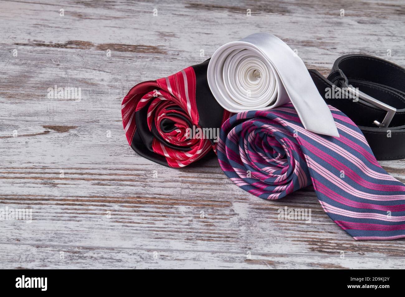 Rolled silk ties and belt Stock Photo Alamy