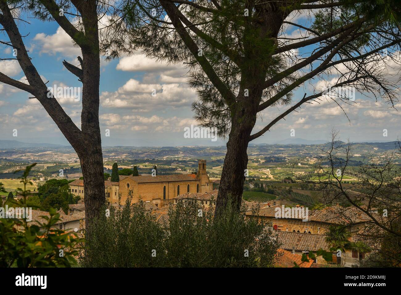 Elevated view of the Church of St Augustine (1280) in the medieval village of San Gimignano, Unesco World Heritage Site, Siena, Tuscany, Italy Stock Photo