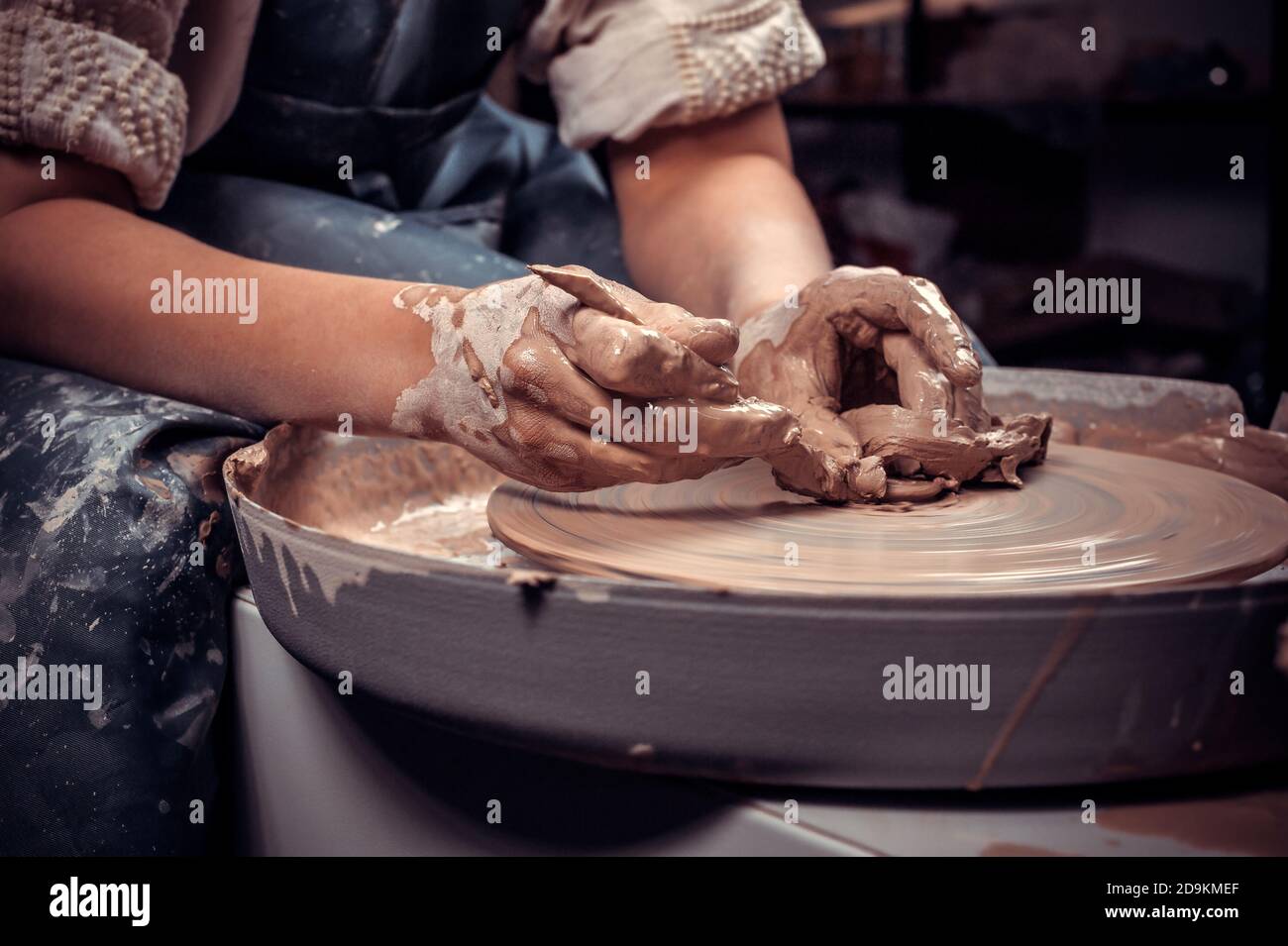 The process of making a clay pot on a potter's wheel. Close-up. Stock Photo