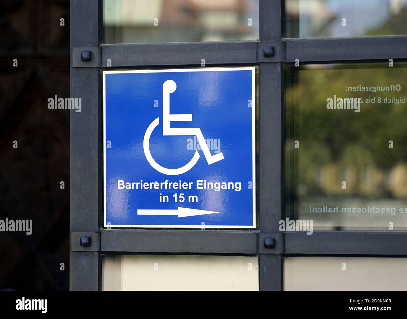 Germany, Bavaria, Upper Bavaria, Altötting district, sign on a church door: Wheelchair users, barrier-free entrance Stock Photo